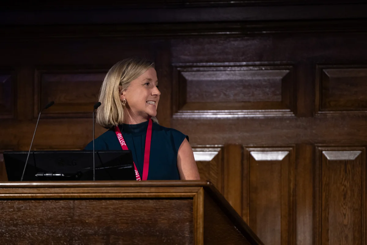 Sinead O'Sullivan moderating a panel discussion, mid-conversation with a co-panellist