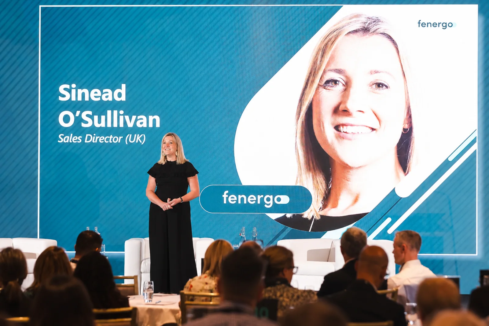 Sinead O'Sullivan hosting from the stage at a conference